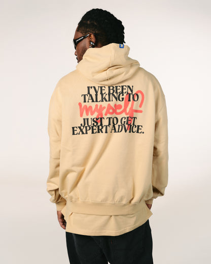 Person wearing a beige hoodie with text on the back against a white background, Hanorac oversize unisex „Talking to Myself” culoare bej, vedere din spate cu print, hip hop takeovers